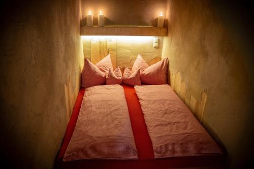 a small bed in a room with lights on it at Turm zu Schloss Schedling in Trostberg an der Alz