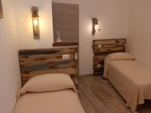 a room with two beds in a room at B&B Ad un passo dal Cielo in Pietrasecca
