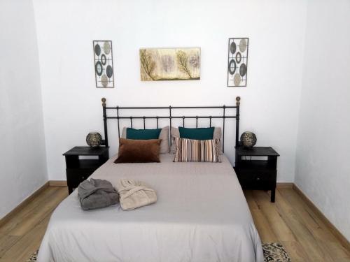 a bedroom with a large bed with two night stands at La Casita de Ainhoa in Agüimes