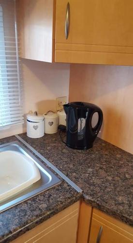 a kitchen counter with a black coffee maker on it at Summer The Grange Ingoldmells 8 Berth in Ingoldmells