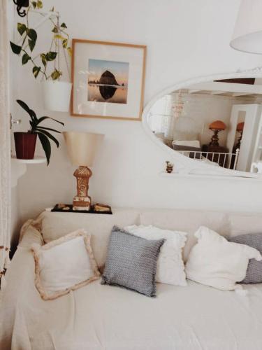 a white couch with pillows in a living room at The Oceanographer's Home, A Chora Hideaway in Serifos Chora