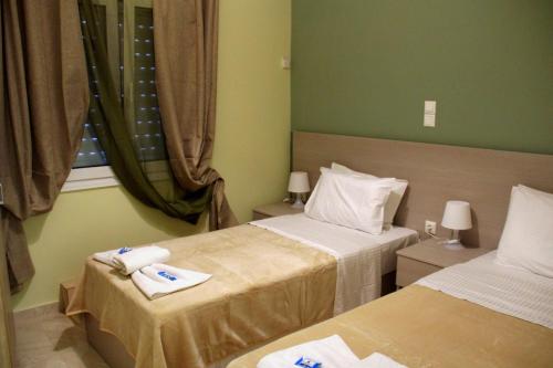 una camera d'albergo con due letti e una finestra di Chania City Home a Chania