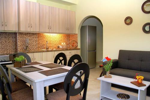 a kitchen and living room with a table and chairs at Chania City Home in Chania