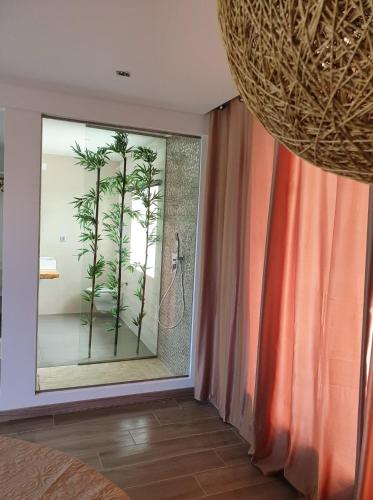 a bathroom with a window with a palm tree in it at PÉROLA D'ÓBIDOS t2 in Óbidos