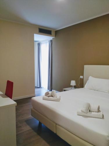 a bedroom with a large bed with towels on it at Verona Enjoy in Verona