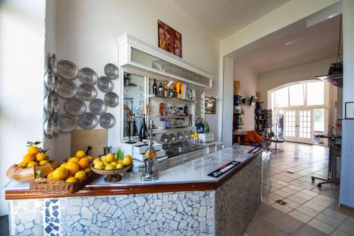 a kitchen with a counter with bowls of fruit on it at B&B Cappotto civico 48 in Pompei
