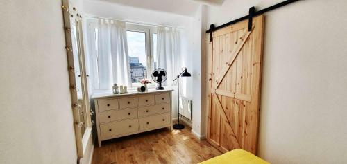 a room with a large window and a wooden door at CityBrejk Zaporoska Wrocław in Wrocław