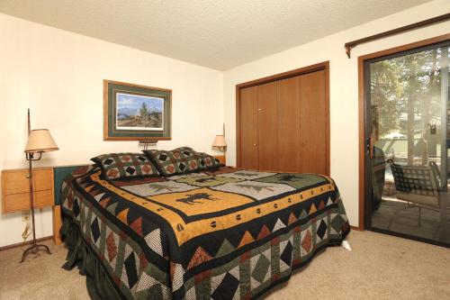 a bedroom with a bed and a sliding glass door at The Forest Neighborhood by Keystone Resort in Keystone