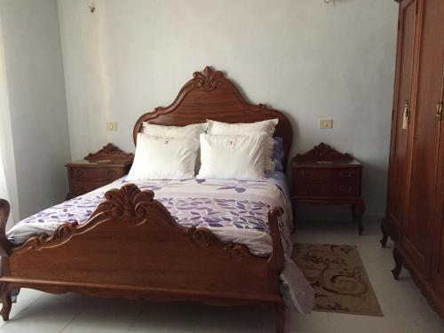 a bedroom with a wooden bed with two night stands at Mi casa in Puerto del Rosario