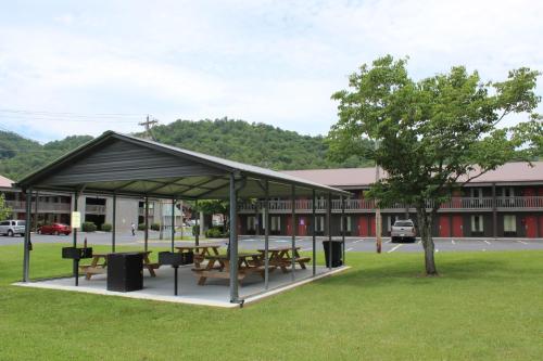 a picnic shelter in front of a building at Great Smokies Inn - Cherokee in Cherokee