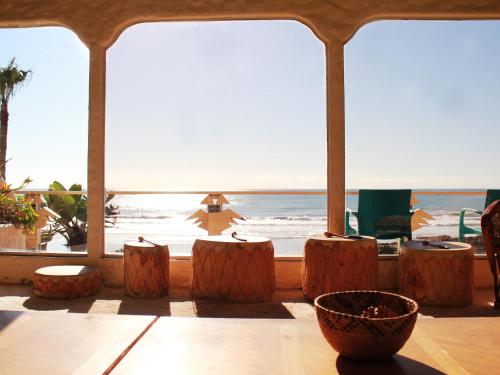 a room with a view of the ocean and some logs at Castillos Del Mar in Rosarito
