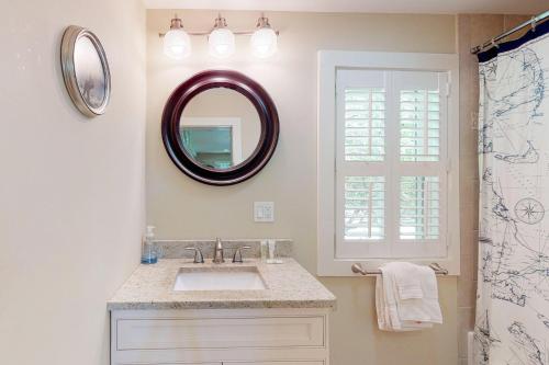 a bathroom with a sink and a mirror at Wendell K. Backus House in Cotuit