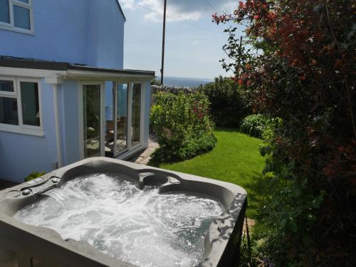 a bath tub filled with water in a yard at Fishermans Cottage in Portland