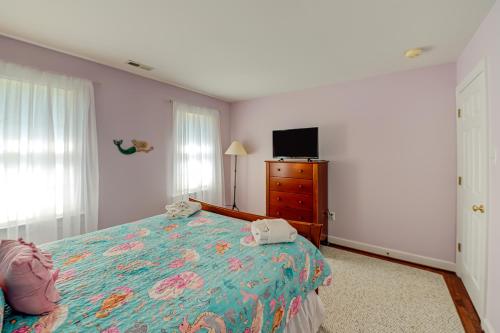 a bedroom with a bed and a dresser and a television at Sunset Cove in Bumpass