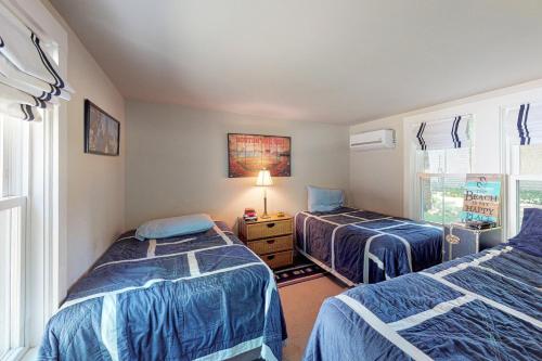 a bedroom with two beds and a window at Wendell K. Backus House in Cotuit