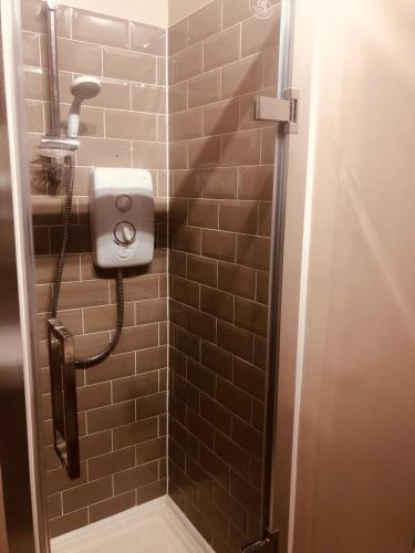 a shower with a soap dispenser in a bathroom at Maritime Pods in Portsmouth
