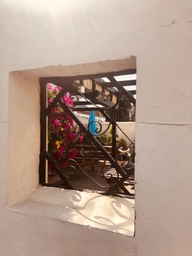 a window with a view of a patio with flowers at Maritime Pods in Portsmouth