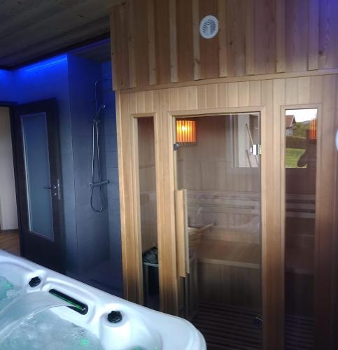 a bathroom with a white sink and a mirror at les charmes du lac Sauna et Spa in Gérardmer