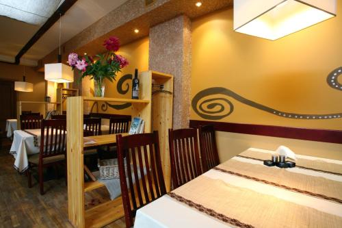 a dining room with a table and chairs at Hotel Dobele in Dobele