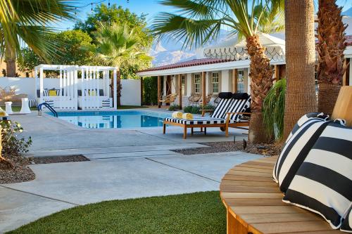 a backyard with a pool and a house with palm trees at Dive Palm Springs in Palm Springs