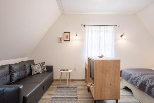 a living room with a couch and a bed at The Starlings Apartments Plitvice Lakes in Plitvička Jezera