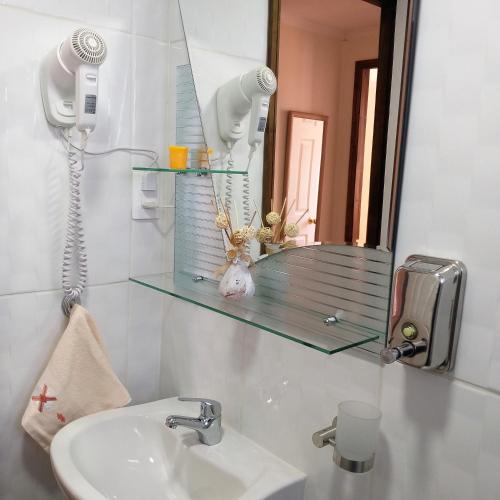 a bathroom with a sink and a mirror at Cabañas Cerro Zapata in Puerto Natales
