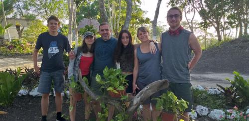 a group of people posing for a picture in a garden at Otoch Béek Calakmul in Chicanna