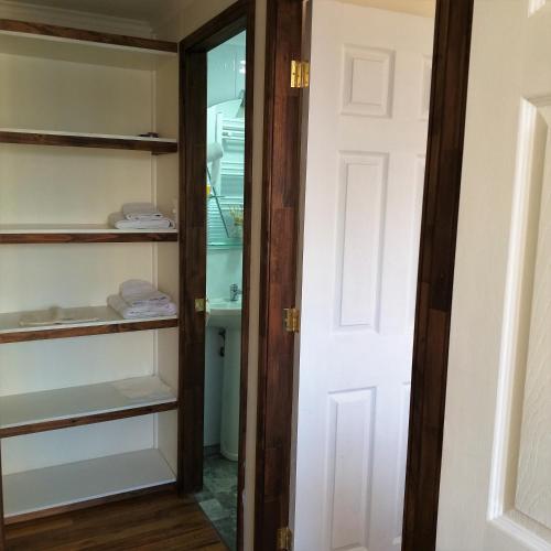 a walk in closet with a glass door at Cabañas Cerro Zapata in Puerto Natales