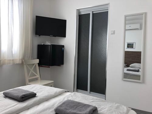 a hotel room with a bed and a television at Holland Lodge Paramaribo in Paramaribo