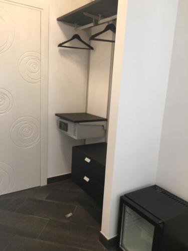 a room with a closet with a tv and a door at Le Divine di via Olivieri - Reception Via XXV Aprile 5 in Levanto