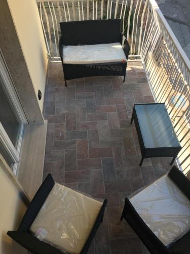 a stairway with a couch and a chair and a table at Le Divine di via Olivieri - Reception Via XXV Aprile 5 in Levanto