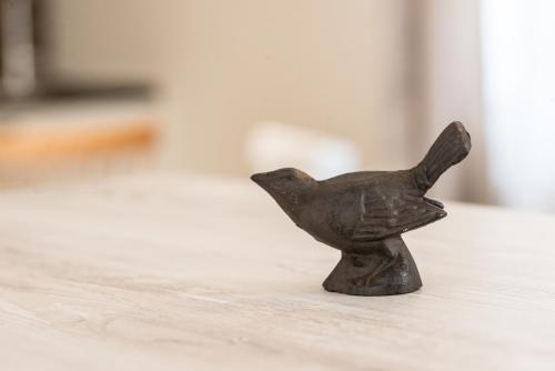 a small black figurine of a dog on a table at The Starlings Apartments Plitvice Lakes in Plitvička Jezera