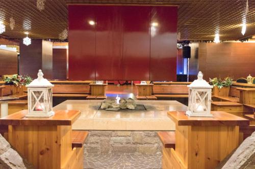 a large room with a table with two lights at Hotel Club Regina E Fassa in Mazzin