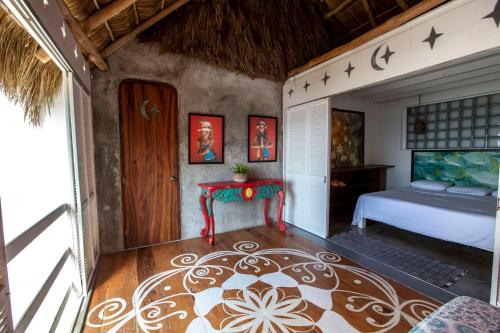 a bedroom with a bed and a table in a room at Casa Love in Sayulita