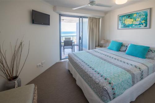 a bedroom with a bed with a view of the ocean at Centrepoint Apartments Caloundra in Caloundra