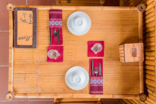 a wooden wall with plates and napkins on it at Hoang Su Phi Lodge in Ha Giang