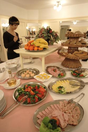 a table with many plates of food on it at Dům Bedřicha Smetany in Luhačovice