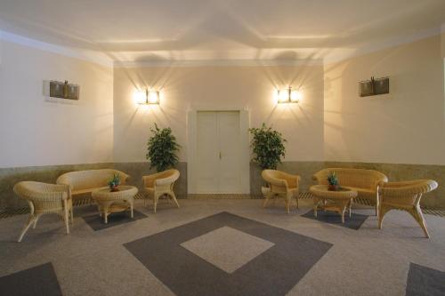 a waiting room with chairs and tables in a building at Dům Bedřicha Smetany in Luhačovice