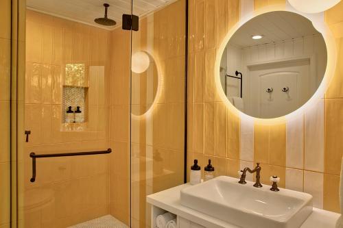 a bathroom with a sink and a shower with a mirror at Dive Palm Springs in Palm Springs