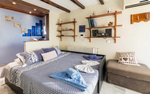 a bedroom with a bed with blue pillows at Top Floor Studio Near Metro&View&200mbps in Athens