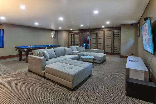 a living room with couches and a pool table at Yacht Club Villas on Hamilton Island by HIHA in Hamilton Island