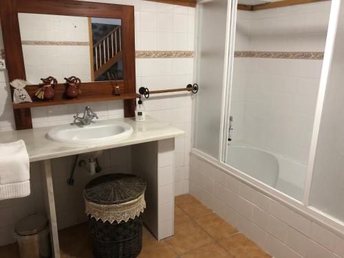 a bathroom with a sink and a shower and a tub at Casa de Lá in Prainha de Cima