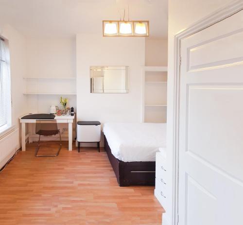 a bedroom with a bed and a desk next to a door at OutRam 26 in Stockton-on-Tees