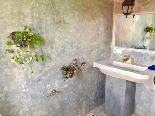a bathroom with a sink and a mirror at Seth Villa by Magampura Resorts in Tangalle
