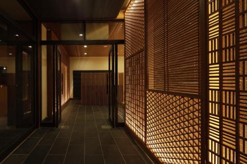 a hallway of a building with wooden walls at Centurion Hakone Bettei in Hakone