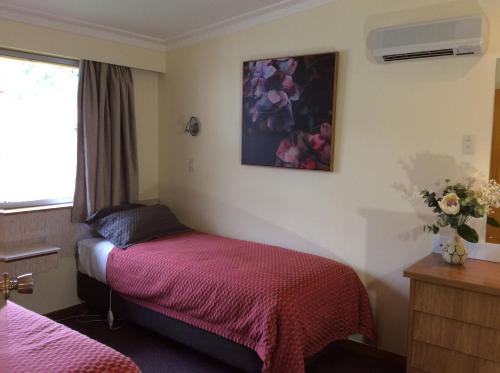 a hotel room with two beds and a window at AAA Marlin Motel in Picton