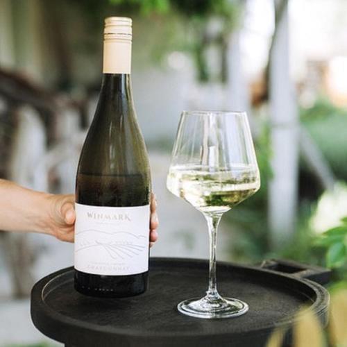 a bottle of wine and a glass on a table at Winmark Wines in Broke