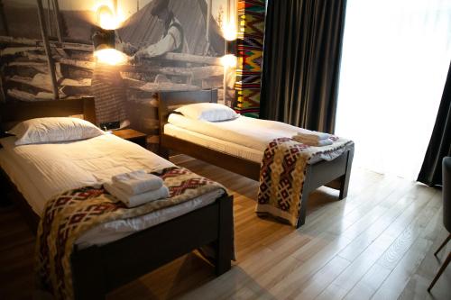 a hotel room with two beds and a window at SPA HOTEL Gora in Bukovel