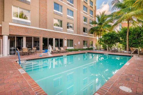 a large swimming pool in front of a building at Cambria Hotel Ft Lauderdale, Airport South & Cruise Port in Dania Beach