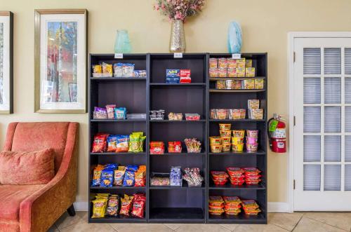 a black book shelf filled with food next to a couch at Quality Inn Roanoke Airport in Roanoke